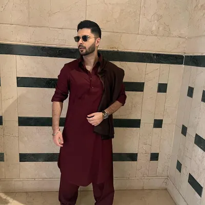 The quintessential Pathani suit in a rich maroon. Worn by Mikhael Kantroo, this outfit showcases a relaxed yet sharp silhouette, perfect for making a confident style statement.