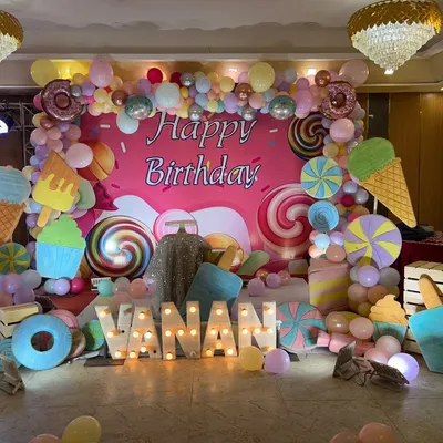 We bring any birthday theme to life, like this vibrant Candyland party. The setup features a custom backdrop with giant lollipops and ice creams, a colorful balloon arch, and large marquee letters spelling out the name for a fun, immersive celebration.
