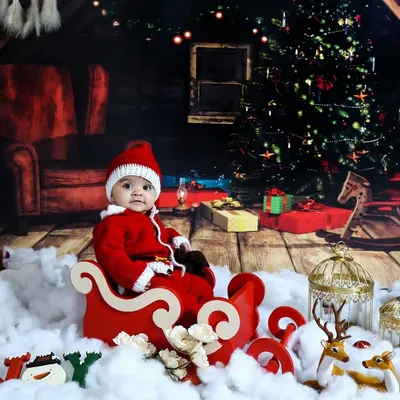 A magical Christmas Eve scene. This cozy, rustic setup with a sleigh, Christmas tree, and warm lights creates the perfect atmosphere for a memorable holiday photoshoot.