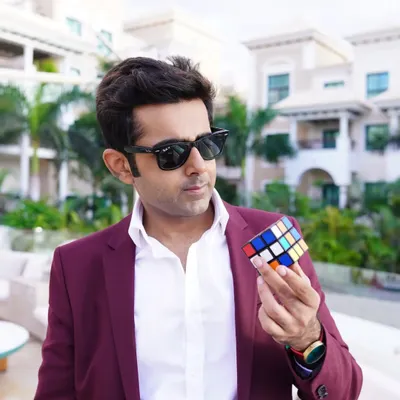 Holding a Rubik's Cube. With 43 quintillion possible combinations, it's a powerful metaphor for the near-infinite possibilities in life. Sometimes you're just one twist away from everything clicking into place.