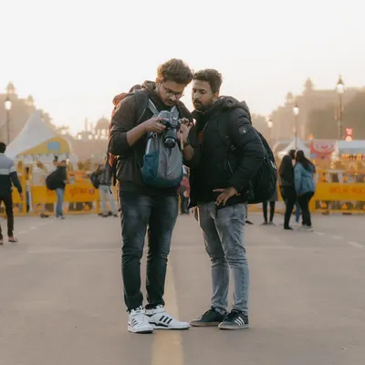 A typical moment during one of our photo walks near India Gate. We'll stop, review the photos you've taken right on the camera, and discuss what's working and how you can improve your composition and settings for the next shot.