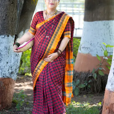 A beautiful solo portrait from a traditional Marathi maternity shoot. The rich colors of the saree and the classic pose celebrate both motherhood and cultural heritage.