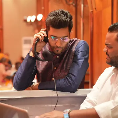 A crucial part of a perfect event is the coordination with the technical team. Here I am doing a final prep and sound check with the DJ to ensure a flawless show.