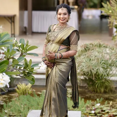 A radiant mom-to-be at her outdoor baby shower. Her beautiful saree and jewelry are perfectly complemented by the rich stain of her custom henna design.