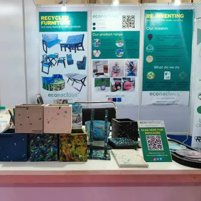 A close-up of our product display at the UP Global Investors Summit. We showcased a variety of our recycled plastic planters, each with a unique color and pattern, along with a QR code for our brochure.