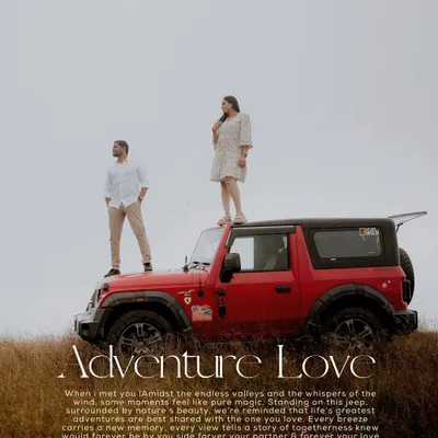 A couple stands atop a red jeep overlooking a vast, grassy valley, perfectly capturing the spirit of an "Adventure Love" story. This is for couples who want an epic and adventurous pre-wedding shoot.