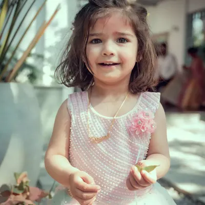An adorable close-up portrait of a young flower girl at a wedding. We take the time to capture beautiful, natural photos of the children and special guests at your event.