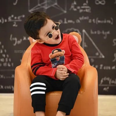 A fun and quirky kid's portrait with a 'little genius' theme, featuring a chalkboard with equations and a cool pair of glasses.
