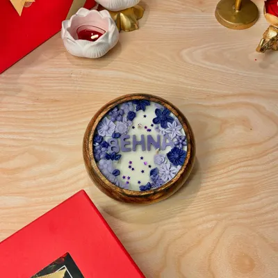 This Rakhi, let your love glow. This is my "Behna" candle, part of the Bhai, Bhabhi, and Behna collection, designed with beautiful purple flowers in a wooden bowl.