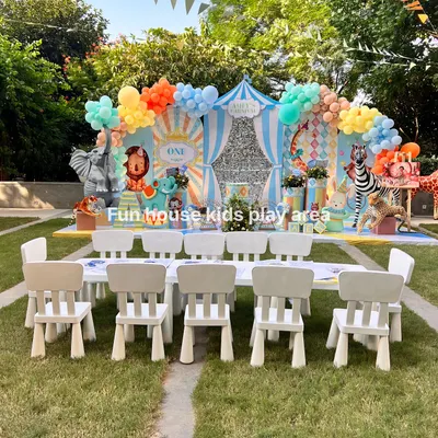 A picture-perfect kids' dining area set against a colorful circus-themed backdrop. Our white tables and chairs provide a clean, comfortable space for children to enjoy their meals and feel like VIPs at the party.