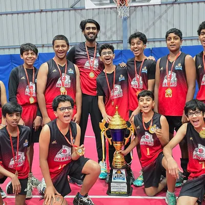 Champions. The Pitch Hawks team proudly holding the Basketball Youth League Season 2 trophy after a season of hard work and dedication.
