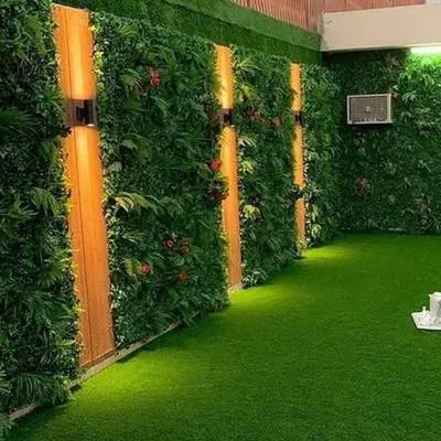 This stunning indoor space features a floor-to-ceiling vertical garden, dramatically lit to highlight its texture. I combined the green wall with wood panels and turf flooring to create an immersive, natural atmosphere indoors.