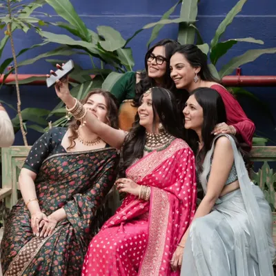 The bride and her bridesmaids gather for a happy selfie, a perfect, unposed moment capturing the joy and friendship of the bride tribe.