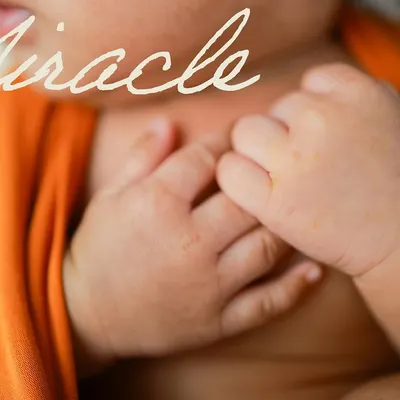 A miracle in the making. This close-up on the baby's tiny, clasped hands shows just how delicate and perfect they are. It's a simple, powerful image.