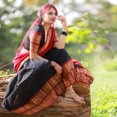 A classic portrait in a traditional red and black langa voni. We found a log by the water, which made for a perfect natural seat to capture this elegant and thoughtful pose.