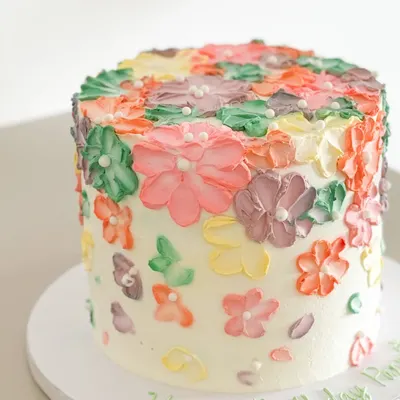 Indulge in the velvety texture and rich flavors of this vegan masterpiece. This cake, covered in hand-piped flowers, is a beautiful example of my custom vegan creations.