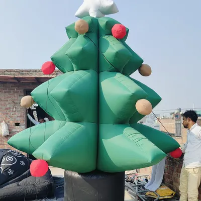 A large inflatable Christmas tree, complete with a star on top and baubles. This was being set up on a rooftop for a client's Christmas display.