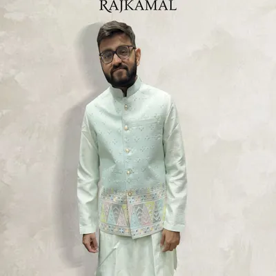 A client looking happy and comfortable in my pastel green kurta paired with a lightly embroidered jacket. This is an ideal outfit for a daytime event or a smaller ceremony.