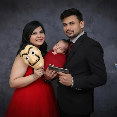 This family wanted to celebrate their love for the show 'Money Heist' in their newborn session. We incorporated the iconic mask and props for a portrait that is both fun and memorable.