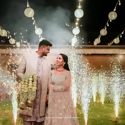 A stunning wide shot of a couple making their reception entrance, surrounded by sparklers and beautiful string lights. I specialize in capturing these dramatic, fairytale moments for your engagement or reception photography.