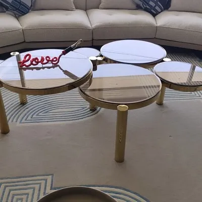 Devised to stand out, our distinctive Aarhus coffee table is not for run-of-the-mill interiors. The design features a cluster of five glass tops at varying heights, all supported by a polished gold metal frame.