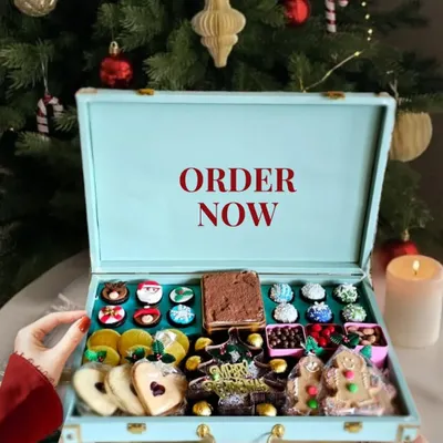 My signature Christmas hamper, presented in a reusable vintage-style trunk, is filled with gingerbread, cupcakes, and more. It’s designed to be a complete holiday gifting experience.