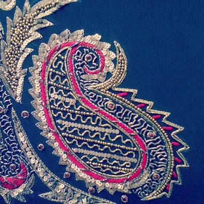 A close-up of a classic paisley motif, intricately embroidered with sequins, beads, and threadwork. This level of detail is what makes my bridal and couture pieces stand out.