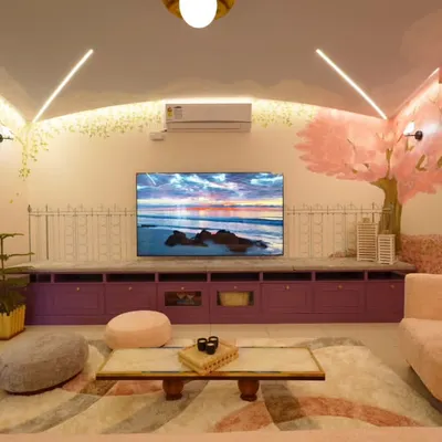A wider view of the Sakura living room, showing how the hand-painted vines on the left wall balance the cherry blossom tree on the right. The design ensures that every element, from the purple TV console to the soft furnishings, is part of a single, harmonious story.