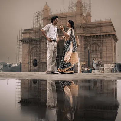 A reflection of love at the Gateway of India. This shot is the essence of my '90s Bombay' series, blending iconic architecture with a quiet, romantic moment to create a powerful, cinematic couple portrait.