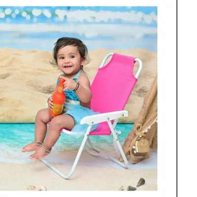 A happy baby girl enjoys her day at the "beach" in my studio. Sitting on a pink deck chair with a toy bottle, her smile is as bright as the summer sun in this fun themed shoot.