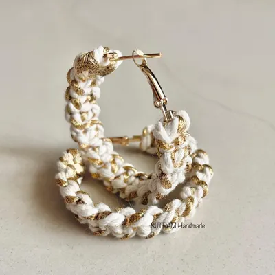 These are my macrame hoop earrings, made with white cotton and a shimmery golden thread. They are lightweight and perfect for parties or festive occasions.