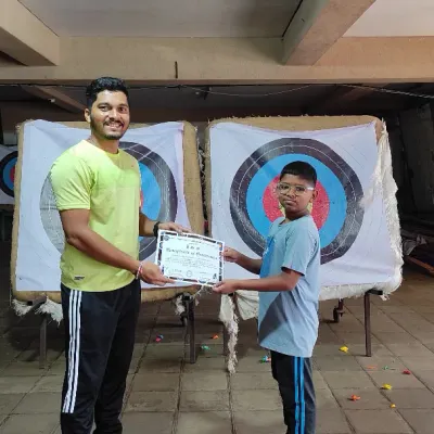 A proud moment for this young archer as he receives his course completion certificate.