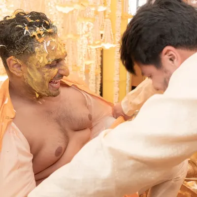 This is what a haldi is all about. The groom's kurta being torn off by his friends is a moment of pure, unscripted fun that I love to capture.