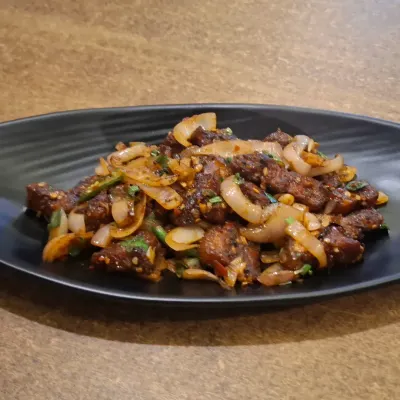 Our spicy pork dry fry is a favourite starter. It's tossed with onions, chillies, and our special mix of spices for a flavour that is both hot and delicious.