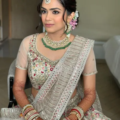Flushed lids, a luminous base, and neutral rose lips. This look is for the bride who dreams of a magical, romantic canvas for her wedding day, with soft florals tucked into her hair.