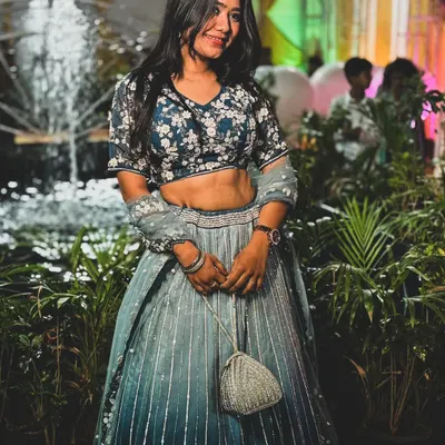 Our client looks stunning in this ombre blue and grey lehenga with a floral embroidered blouse. It's a perfect choice for a sangeet or reception party.