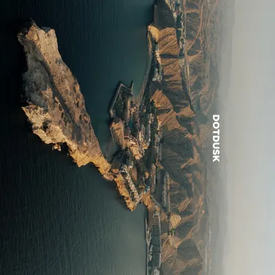 An aerial view of the dramatic cliffs and serene waters of Muscat, Oman. This was the spectacular backdrop for a wedding where modern luxury met timeless tradition.