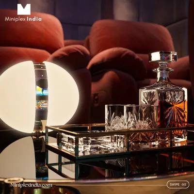 It's the little details that complete the luxury experience. A custom side table with a decanter and glasses, softly lit by an elegant lamp, makes the theater feel like a private, first-class lounge.