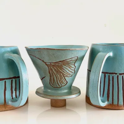 A beautiful, nature-inspired pour-over coffee set with matching mugs, created by a student as a special, handmade gift.