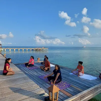 A morning meditation session on our private dock in the Maldives. We begin each day by grounding ourselves, surrounded by the endless blue of the ocean and sky.
