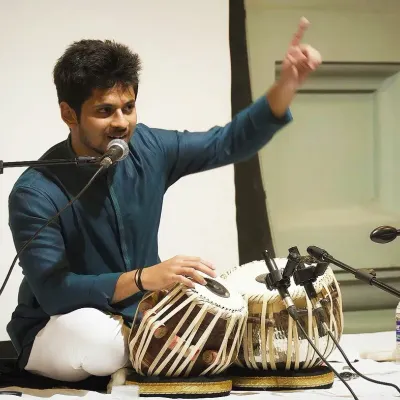 Explaining a rhythmic concept to the audience during a solo performance. I believe in making classical music accessible and sharing the stories behind the compositions.