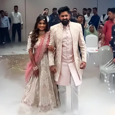This is a beautiful shot of a couple I styled for their wedding event. The groom's light pink sherwani with geometric texturing perfectly complements the bride's white and pink embroidered lehenga.