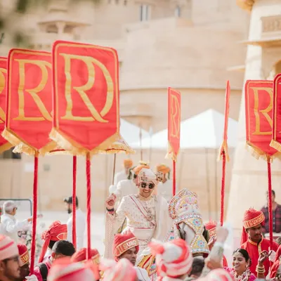 It's the little things that pack the most meaning. For this royal Rajasthani wedding, we created personalized flags with the couple's monogram, adding a regal and bespoke touch to the groom's procession.