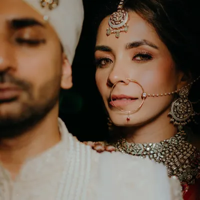 An intense and artistic close-up of the bride, focusing on her stunning makeup and jewelry. This is a perfect example of our signature "It-girl" bridal portraits.