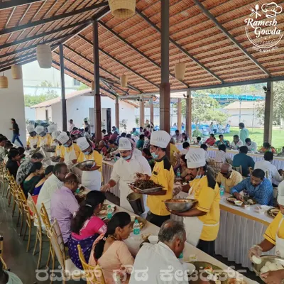 Our staff, dressed in uniform, serving guests with care during a lunch service. We ensure every guest is attended to personally.