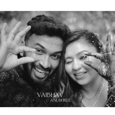 A fun and playful black and white shot of the newly engaged couple showing off their rings. It's a perfect way to announce the new beginning!