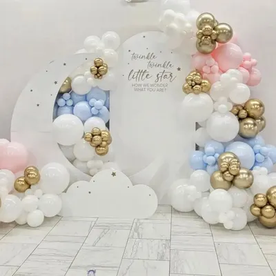 A beautiful gender-neutral "Twinkle Twinkle Little Star" baby shower setup. The design features a large moon cutout backdrop surrounded by organic balloon clouds in pastel pink, blue, white, and chrome gold.
