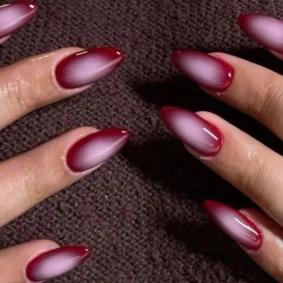 A dramatic and moody red and black aura nail. The gradient effect is perfect for a bold, vampy look.