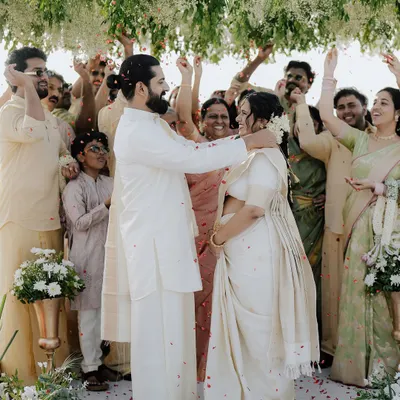 Surrounded by the love and blessings of family, the couple shares a moment of pure joy during their Kerala wedding ceremony.