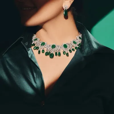 Your daily dose of greens, but make it emerald. A stunning emerald and diamond necklace paired with a deep green silk shirt for a powerful, monochromatic look.